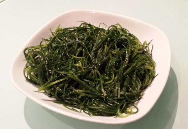 Agretti served with olive oil and lemon. By Catherine Simes.