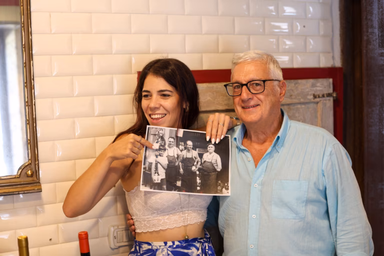 Our guide showing a photo of a longtime restaurant owner