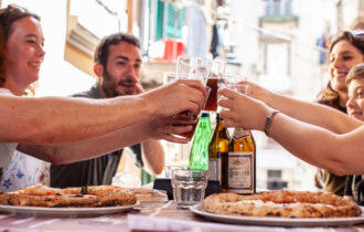 Smiling group with pizza and drinks