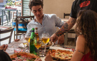 table being served pizza