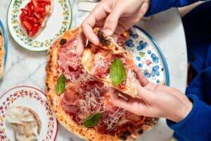 person_eating_pizza_at_pizzium_pizzeria_in_milan