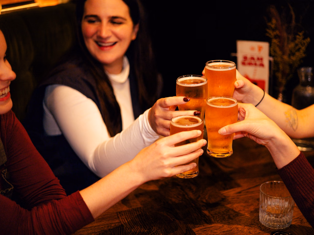 Guests raising a toast with a refreshing Scottish lager