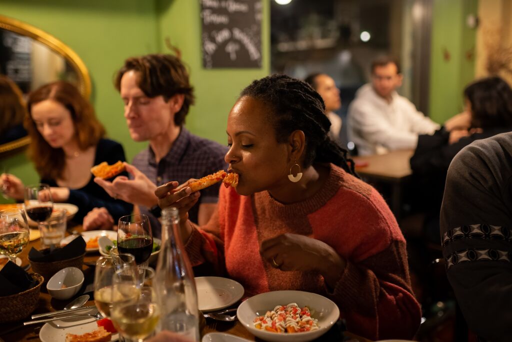 A woman enjoys a Spanish tapa on an Eating Europe tour