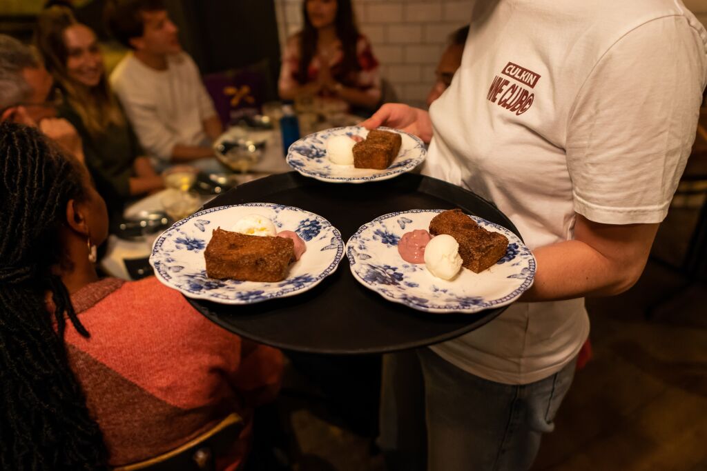 A tray of desserts comes out of the kitchen in a Barcelona tapas bar